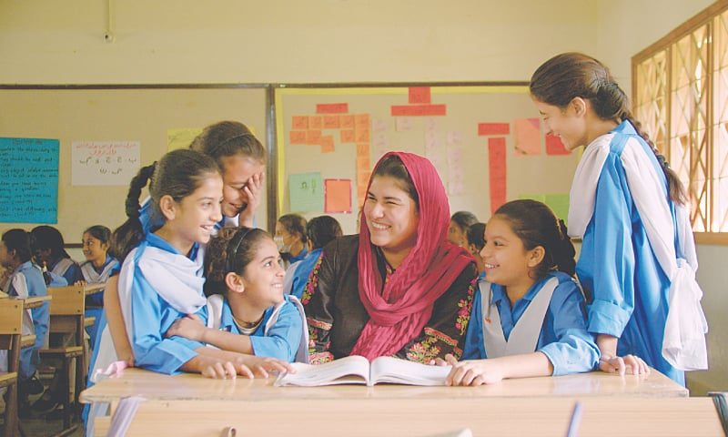 image of teacher with students in physical class